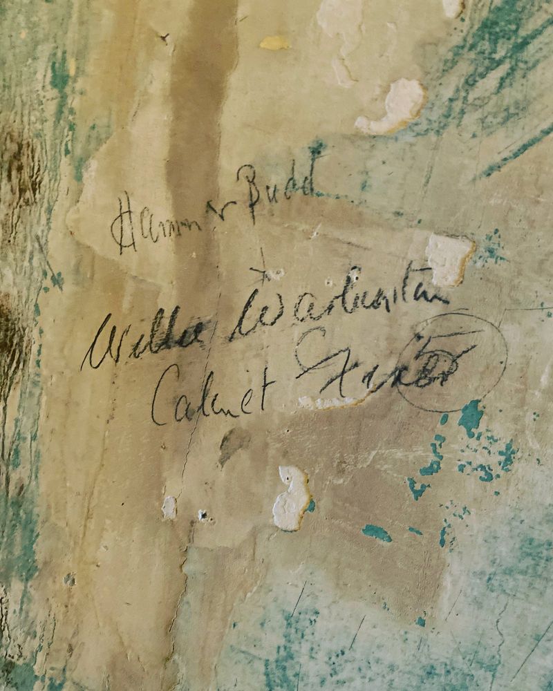 Cabinet maker's pencilled signature on the wall