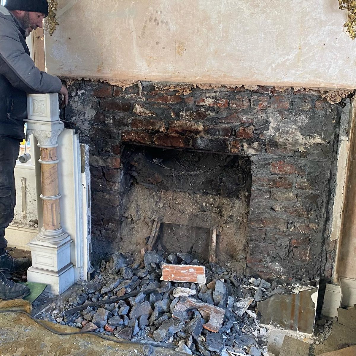 The marble fireplace being removed for restoration (4/5)