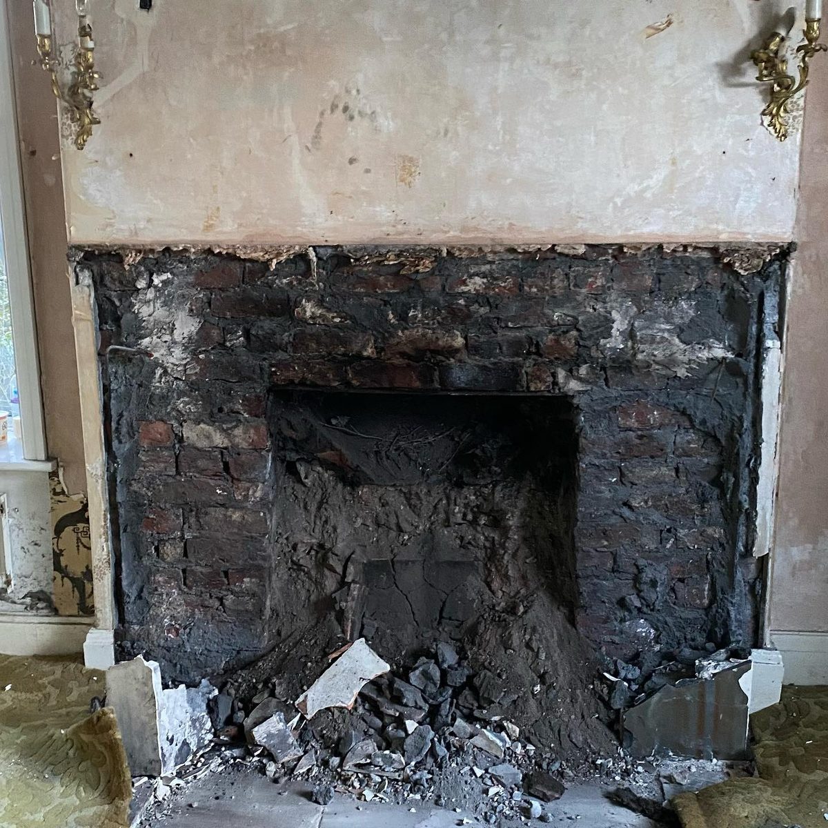 The marble fireplace being removed for restoration (5/5)